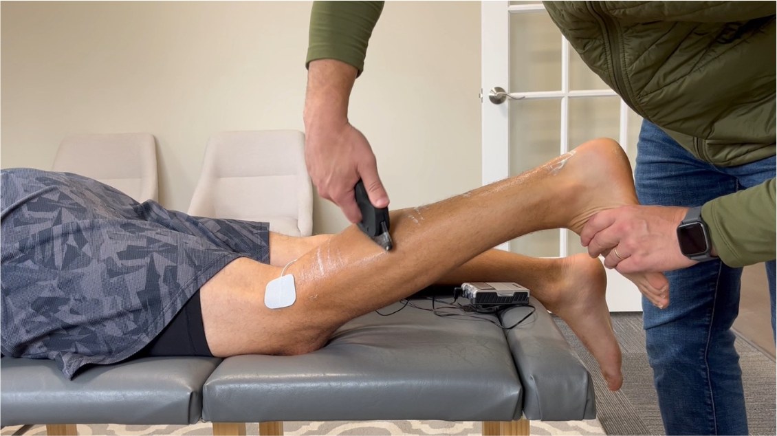 Clinician treating a patient with a MyoWorks instrument in a clinic